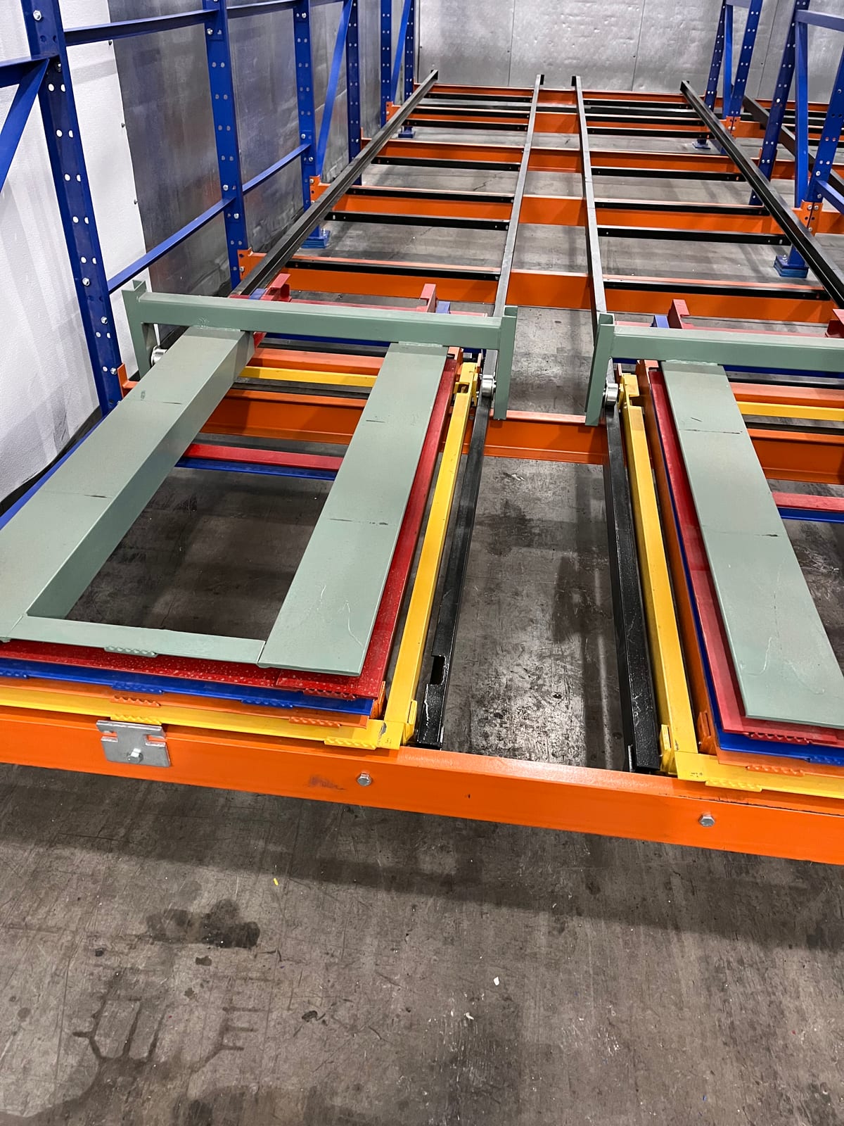 Nested push-back rack carts and rails running six pallets deep in a single lane